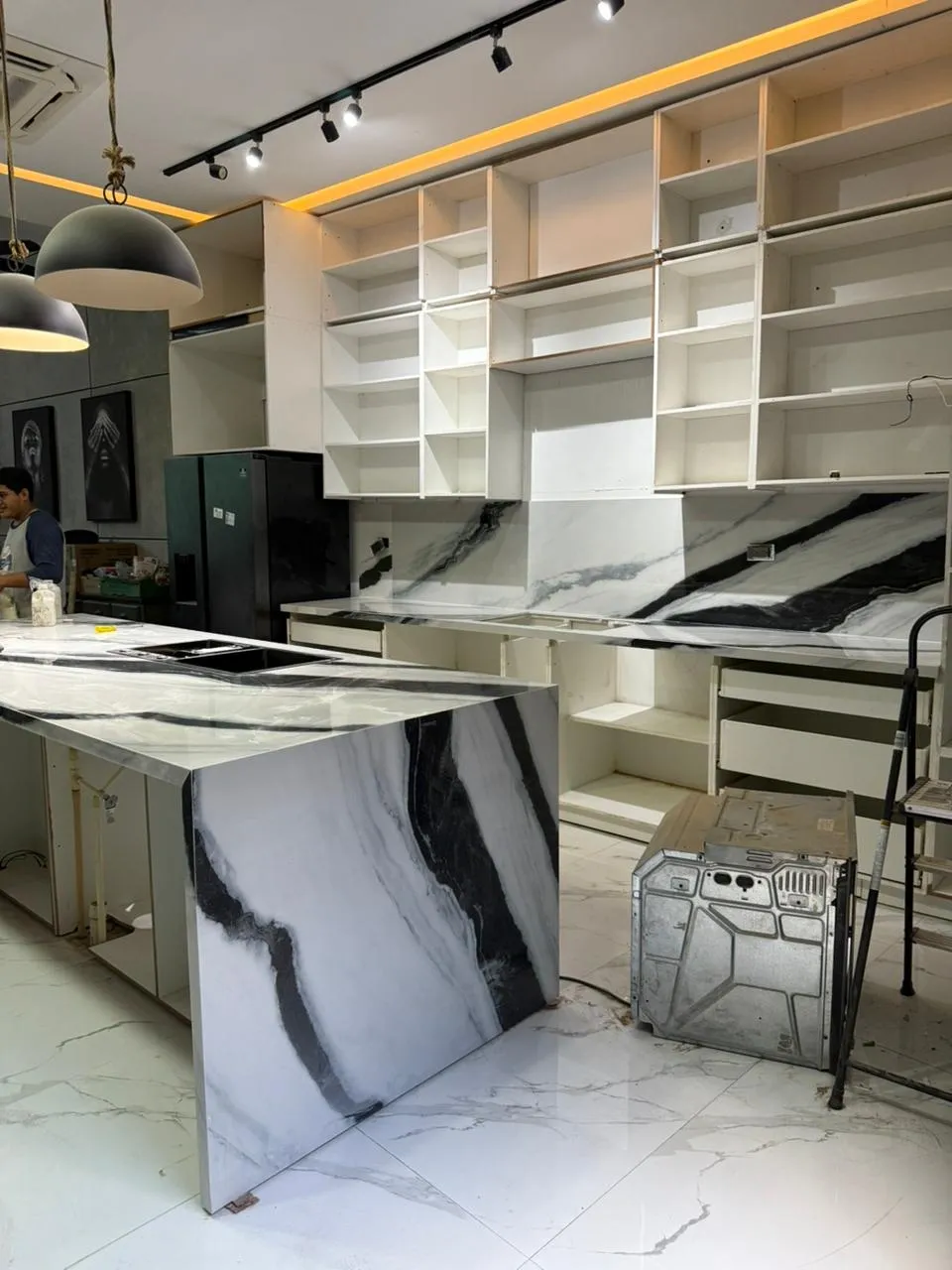 Detalle del envolvente de la isla y backsplash en Panda White con vetas marcadas